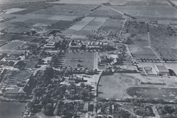 Photo: Aerial photograph of Davis campus, looking west, taken in 1938; from the air, one may see North, South, East and West Hall, Walker and Hart Hall, Hickey Gym and Toomey Field, while in the distance the fields that are later developed into Segundo Area, Tercero Area, and campus apartments may be seen.